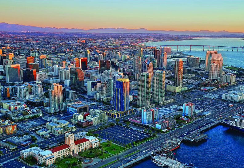 A stunning aerial view of San Diego County, showcasing the city skyline, waterfront, and Coronado Bridge.