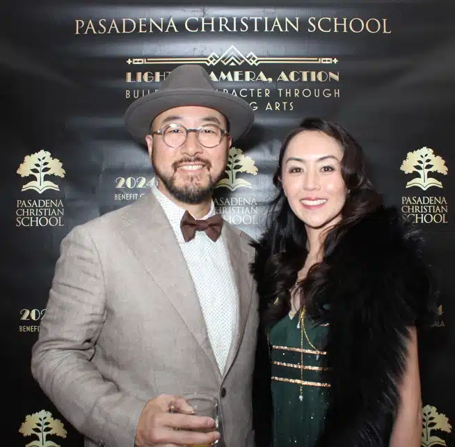 Elegant couple poses at Pasadena Christian School's themed event celebrating a company milestone.
