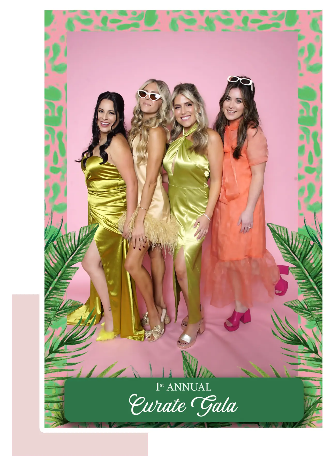 Four stylish ladies posing in a rented photo booth, dressed in elegant gowns at the Curate Gala event.