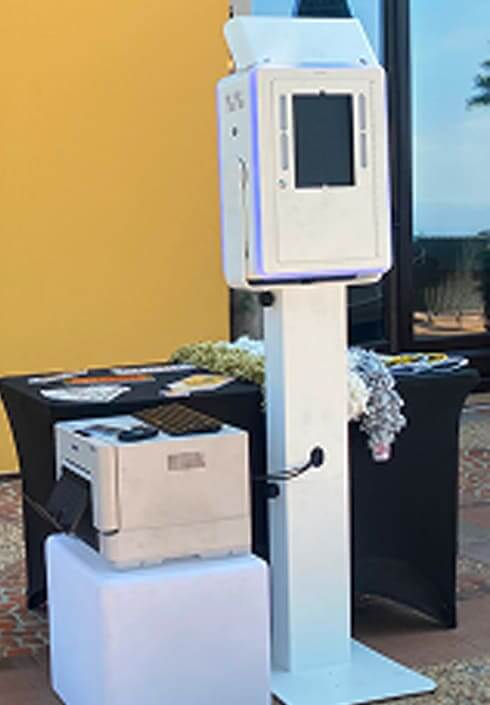 Classic photo booth rental set-up with printer and backdrop, ideal for weddings, birthdays, and corporate events.