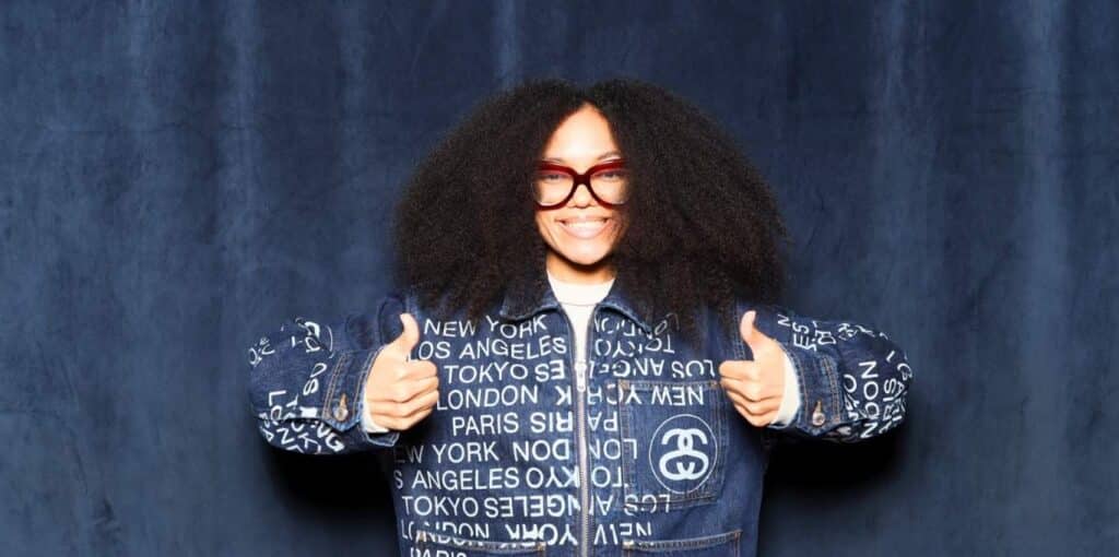 Stylish smiling lady in denim outfit at Flyana Boss photo booth rental in Chula Vista