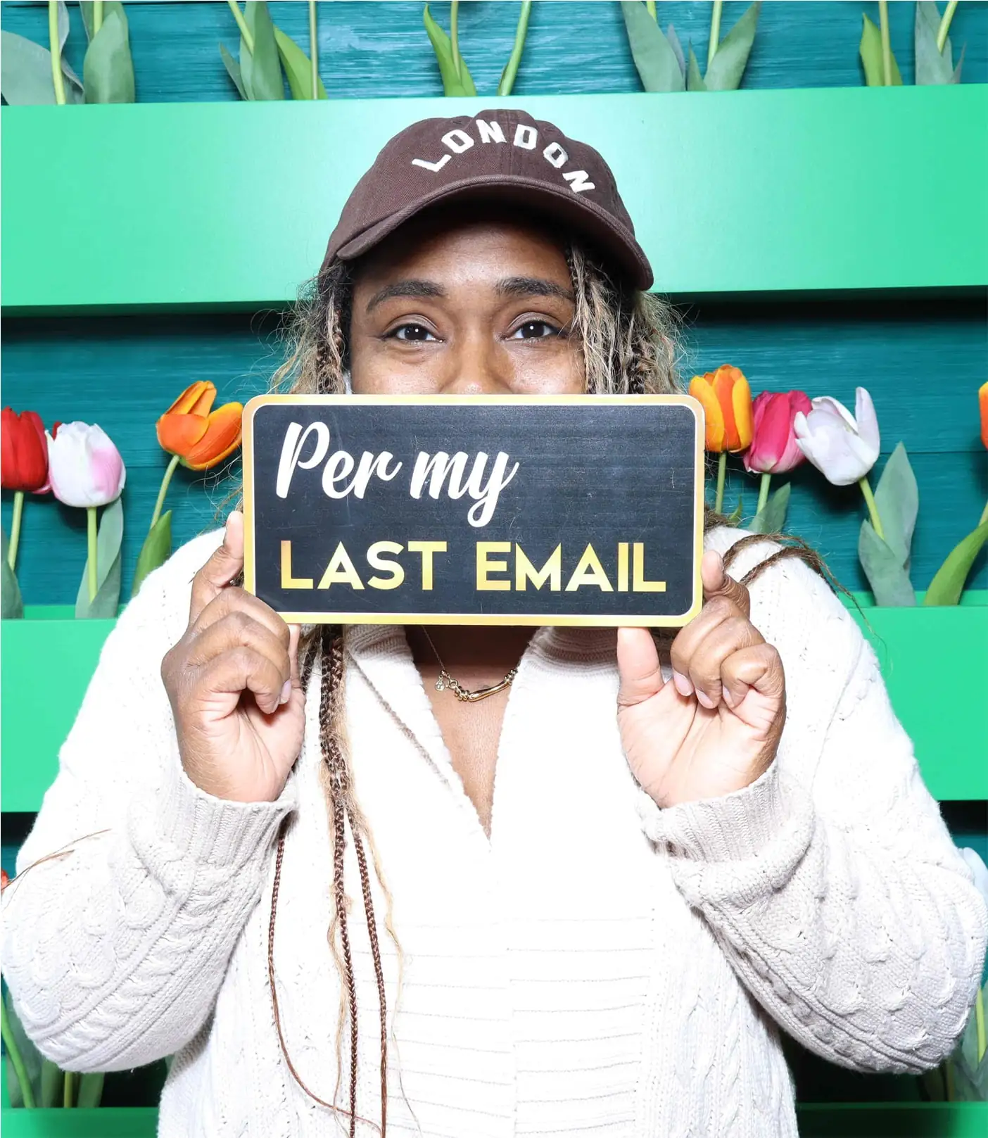 Woman posing with “Per my last email” prop in photo booth rental in Pasadena with tulip backdrop.