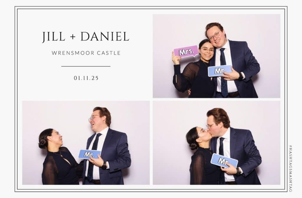 a couple posing for a photo in a wedding photo booth while holding a retro brick phone