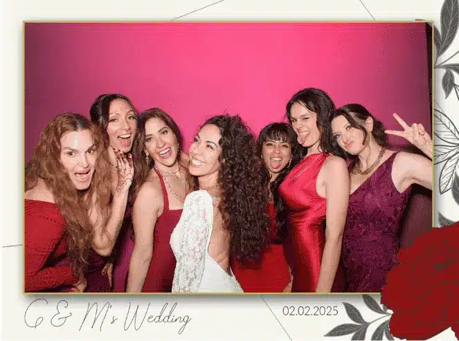 Bride and bridesmaids smiling in red-themed wedding photo taken by Glam Photo Booth.