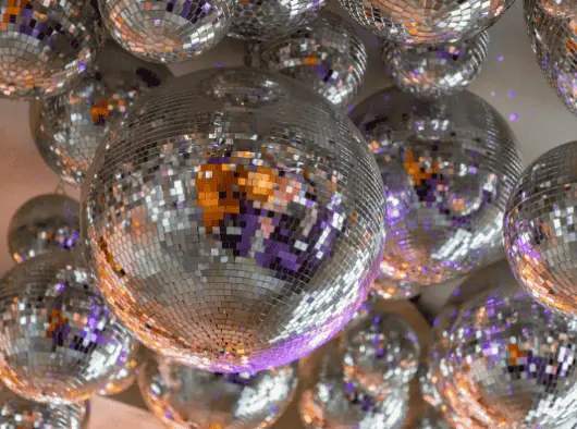 many shiny disco balls hanging from the ceiling