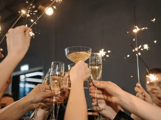 A group of people toasting with sparklers