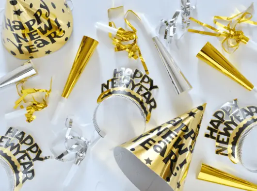 new year's party supplies, including party hats, streamers and confetti