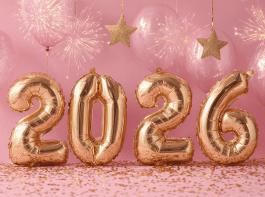 Bright gold balloons spell out the year 2026, surrounded by pink balloons and golden stars for a festive celebration.