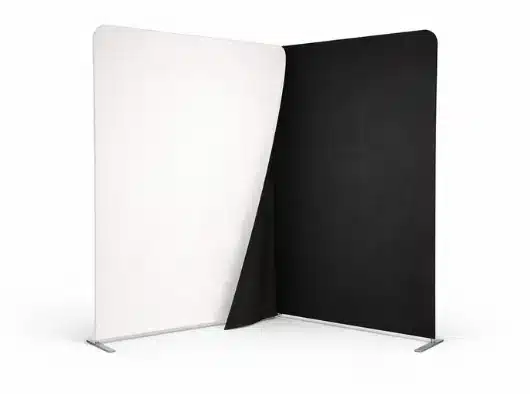 A backdrop is divided into a white section on the left and a black section on the right.