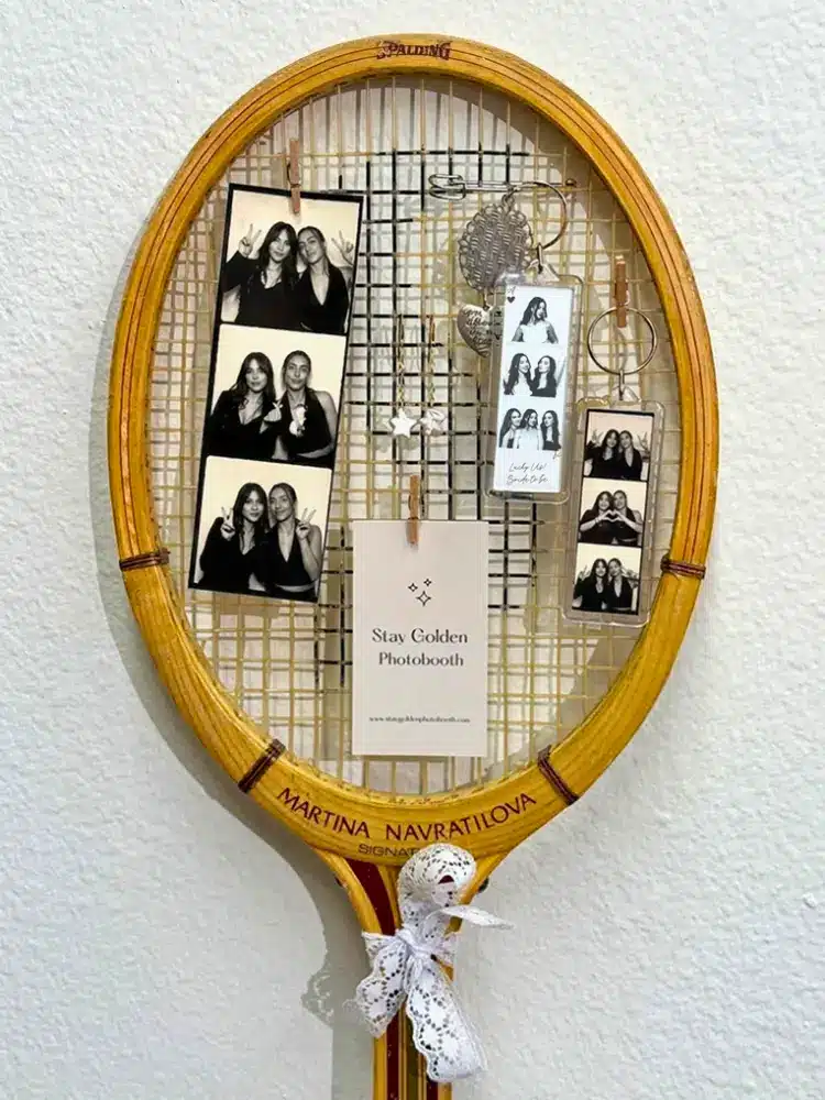 3 Photo Booth Keychains on a vintage tennis racket