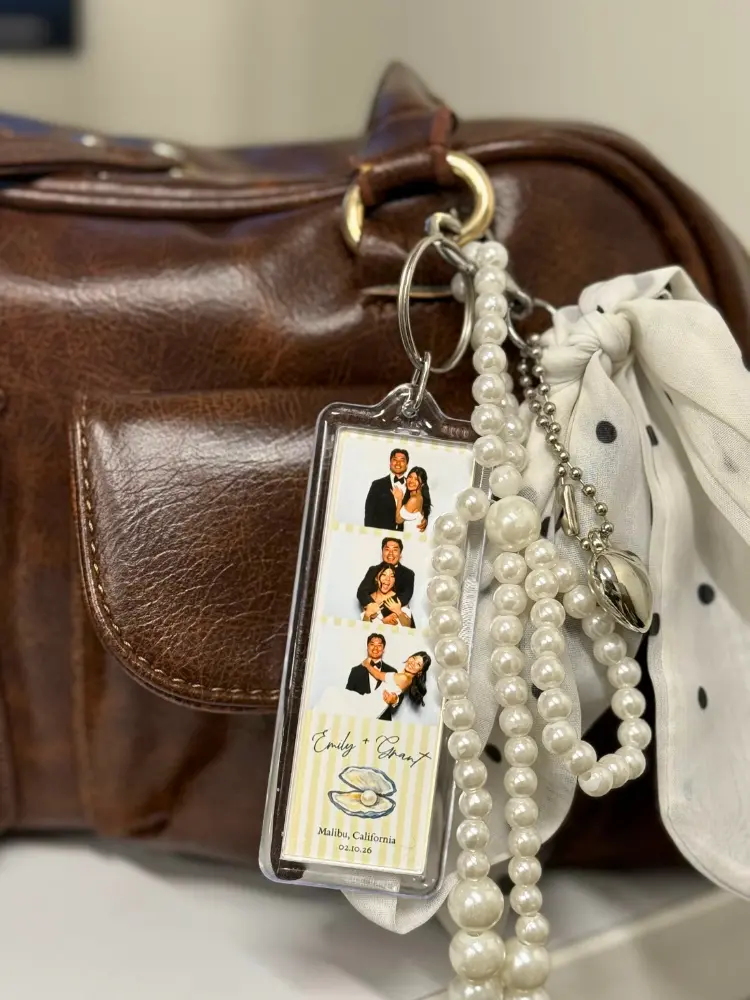 Photo Booth Keychain ttached to a brown leather bag