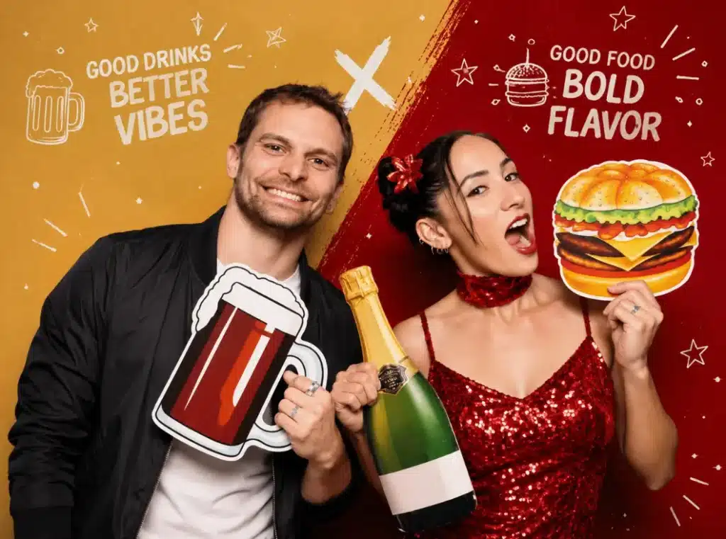 Two guests pose with food and drink props in a co-branded photo booth activation backdrop.