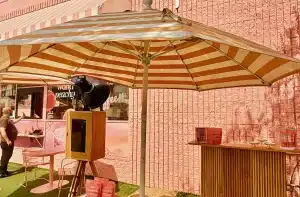 Wooden Glam Photo Booth setup for Whata Peach x Blume brand activation outside a pink storefront.