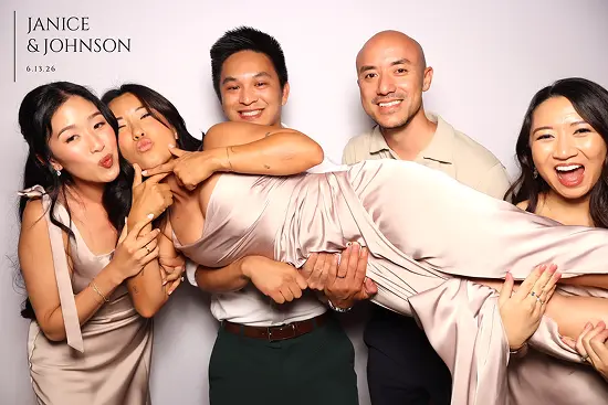 Friends laugh as they lift one woman horizontally