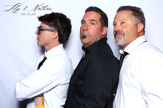Three men stand in a row and look upward with serious expressions