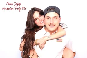 Woman wraps her arms around a man from behind in a playful piggyback photo booth pose ideas.