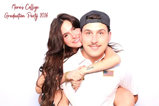 Woman wraps her arms around a man from behind in a playful piggyback photo booth pose ideas.
