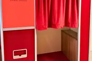 Red Enclosed Vintage Booth with privacy curtain, built-in bench, and photo print slot.
