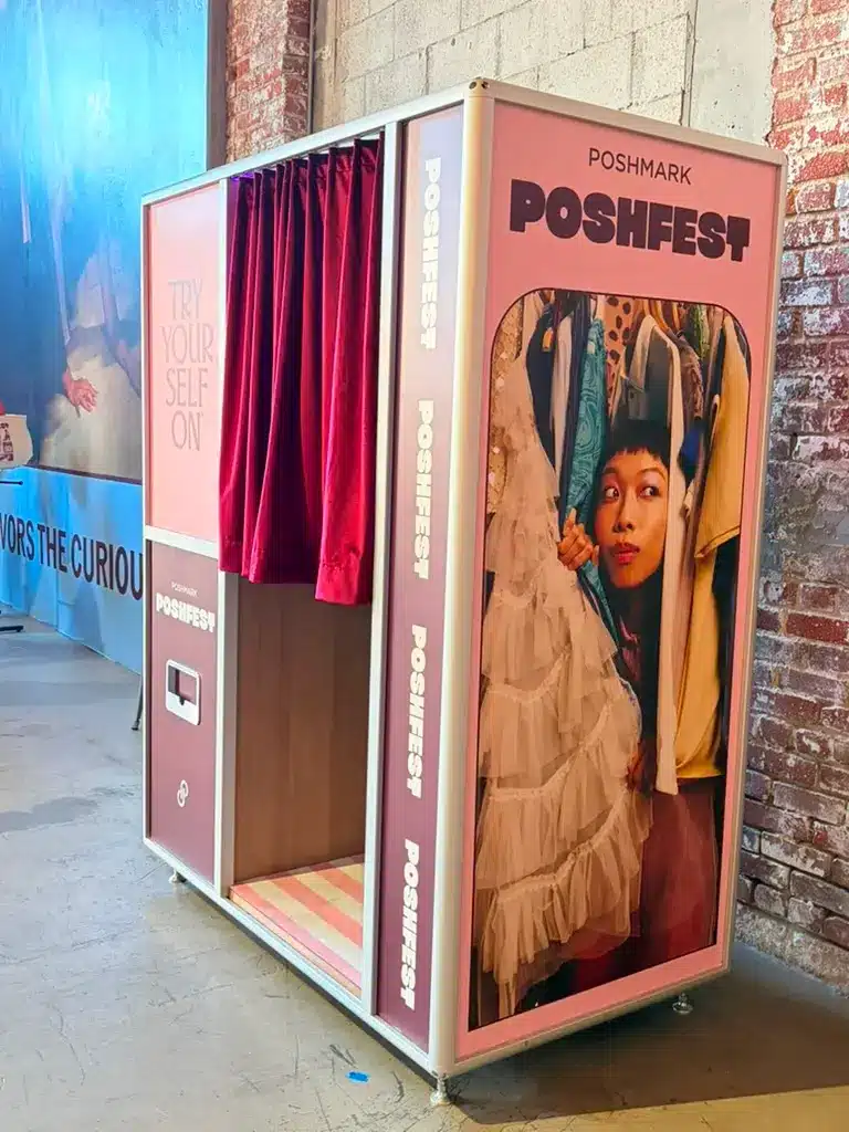 Custom Enclosed Booth at Poshmark Poshfest with burgundy curtains, pink branding, and fashion graphics.